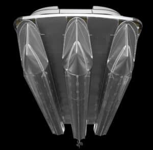Top view of a futuristic, metallic conceptual model with three elongated, streamlined structures resembling ship hulls or rocket components, set against a black background, showcasing a sleek and aerodynamic design.