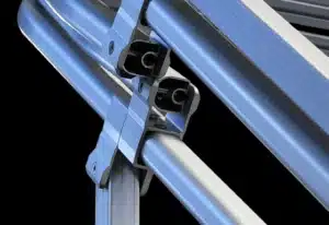 Close-up of a metallic joint structure featuring interconnected aluminum extrusions with screws securing them together. The components are silver and gray, with a sleek and modern design, set against a black background.