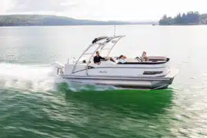 Family rising in a white pontoon boat in the sea.