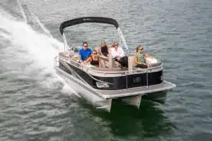 Family of 5 riding on a pontoon boat in the middle of the ocean