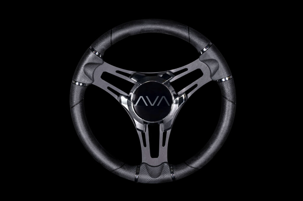 A black and silver car steering wheel with the word "AVA" in the center, set against a black background.