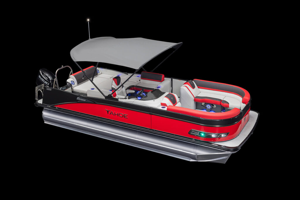 A boat with a gray Bimini top is shown against a black background. The boat has white and red cushioned seating, a steering console with a blue-styled steering wheel, and appears to be designed for leisure and comfort.