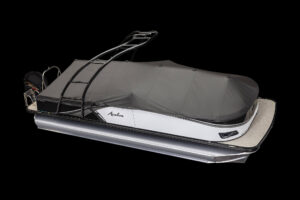 A pontoon boat with a sleek, modern design and a black protective cover. The boat has a sturdy ladder and a control panel at the rear, along with an outboard motor. The name "Avalon" is visible on the side. The image has a black background.