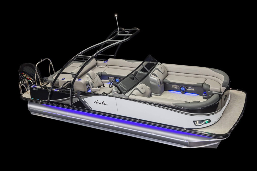 Close-up view of the corner of a boat, showing a sleek design with a green navigation light and the model name LSZ Elite displayed on the side. The boat features a stylish, metallic finish and beige flooring, with blue LED lights illuminating the lower section.
