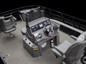 The image displays the interior of a pontoon boat featuring a control console with a steering wheel, various gauges, and controls. Adjacent are two captain's chairs and a fire extinguisher mounted near the console. The flooring appears to be carpeted.