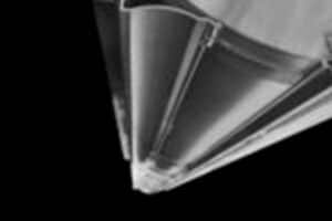 Close-up image of the tip of a graphite assembly within a nuclear reactor, displaying detailed structural features in black and white. The assembly components are clearly visible against a dark background, highlighting the intricate design and construction.