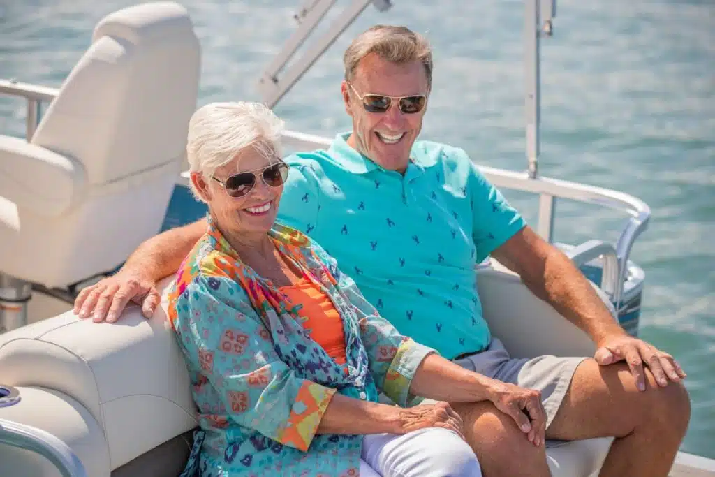 A couple sitting and laughing on an Avalon LS Cruise Rear Bench