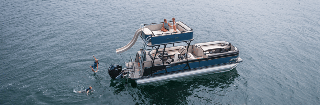 An Avalon Pontoons boat with a double decker in the middle of the ocean
