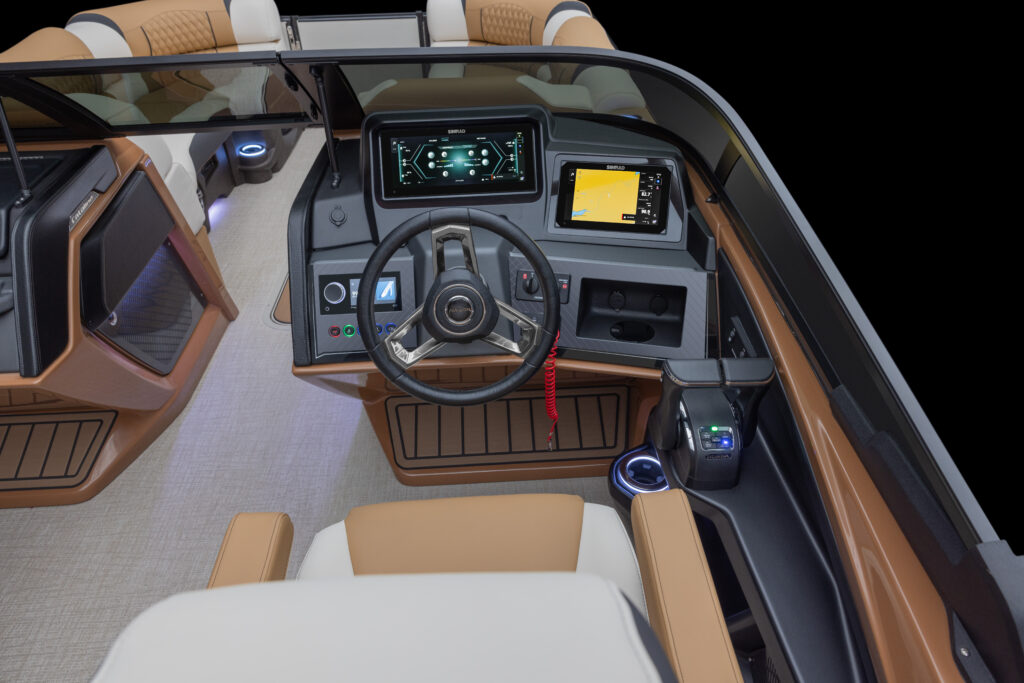 Interior view of the Catalina Cruise Rear Bench Windshield showcasing a contemporary boat cockpit with a steering wheel, digital control panels, GPS display, and brown-beige upholstered seating. The design features wood-like flooring and ambient lighting.